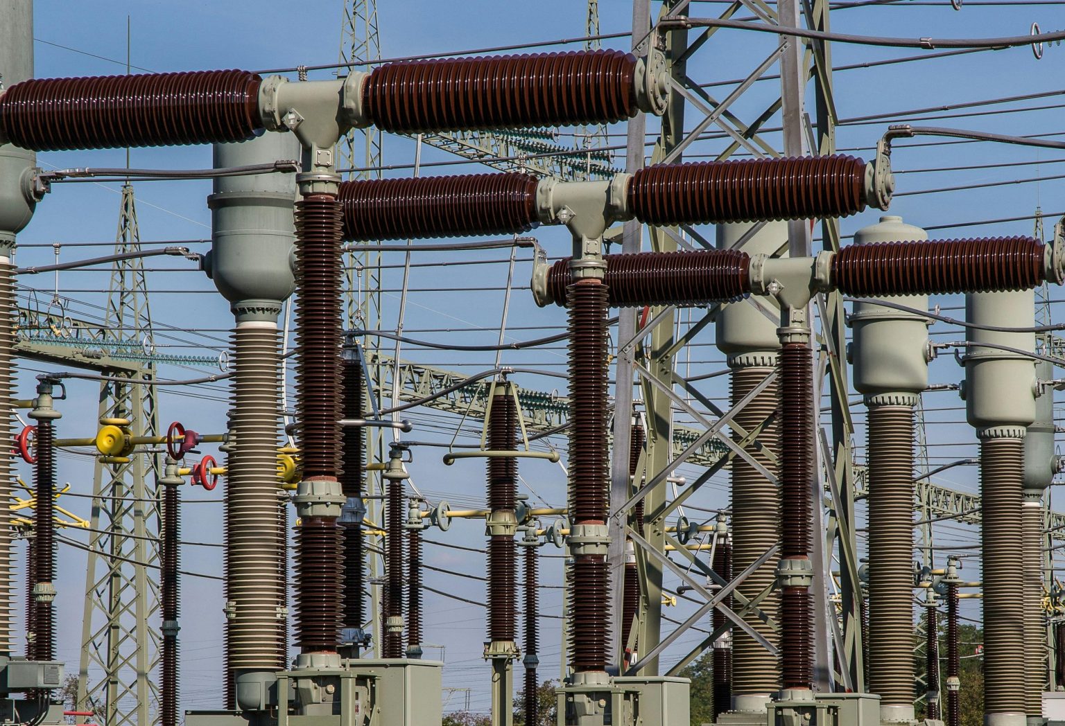 Detailed view of high voltage electrical substation with transformers and power lines.