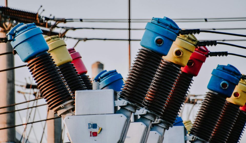 Colorful high voltage insulators in an electric substation highlighting power infrastructure.
